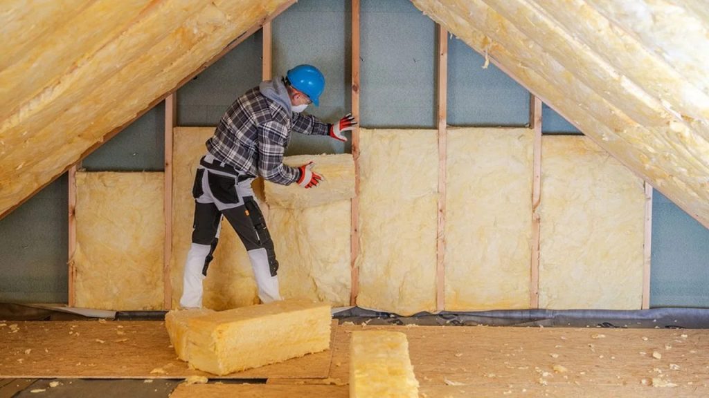 Technician installing attic insulation in a Puyallup, WA