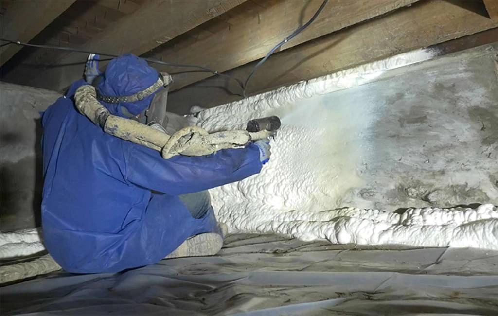 Technician applying spray foam insulation in a Puyallup, WA crawl space